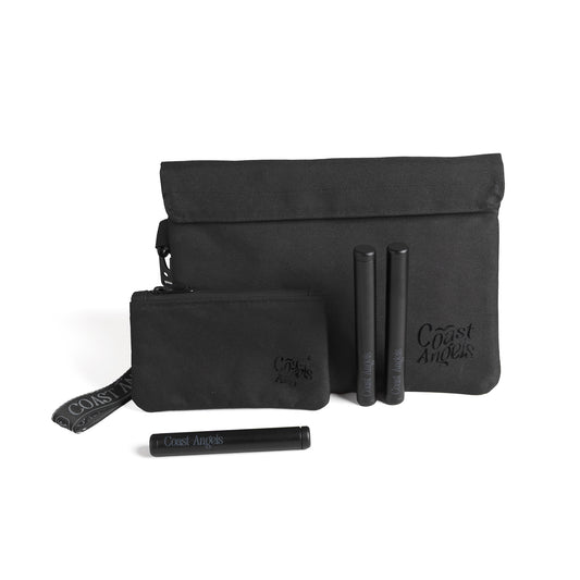 Set of black bags and travel items with 'Coast Angels' branding on a white background